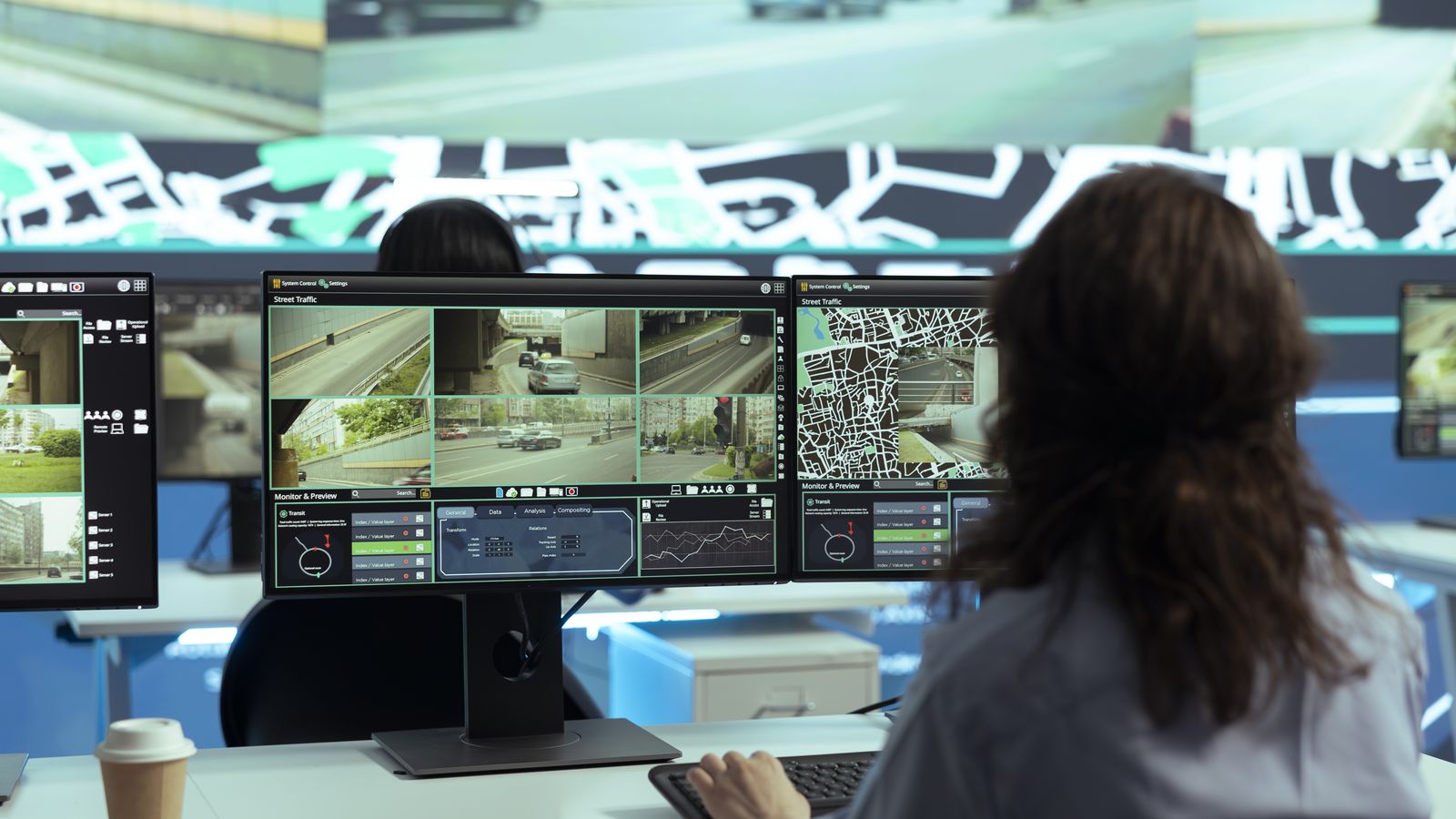 An operator watching a bank of live camera feeds in a surveillance control room